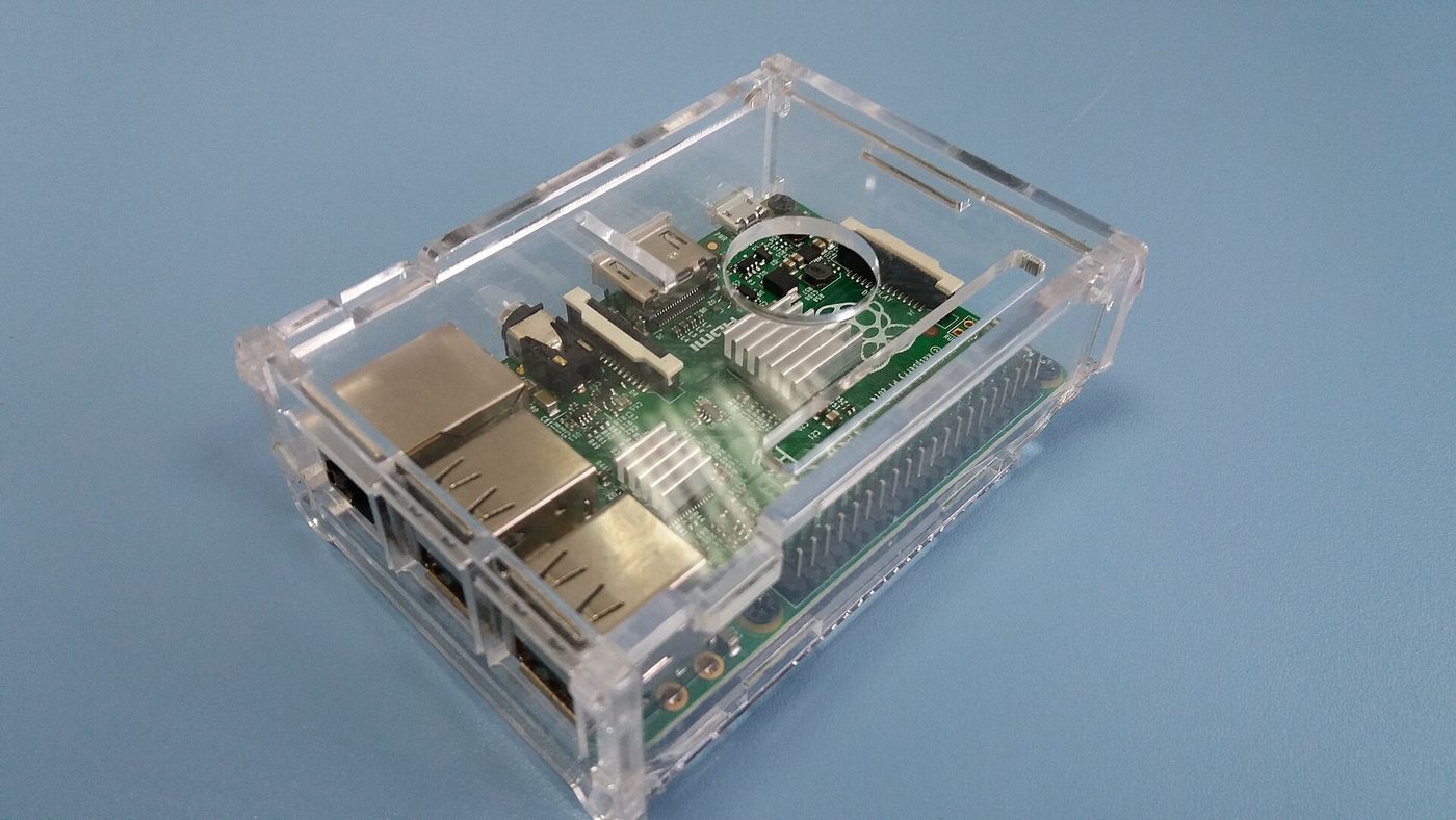 A Raspberry Pi single-board computer in a clear case, its ports and GPIO header visible.